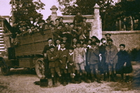 Photographie noir et blanc montrant de jeunes garçons descendant d'un camion.