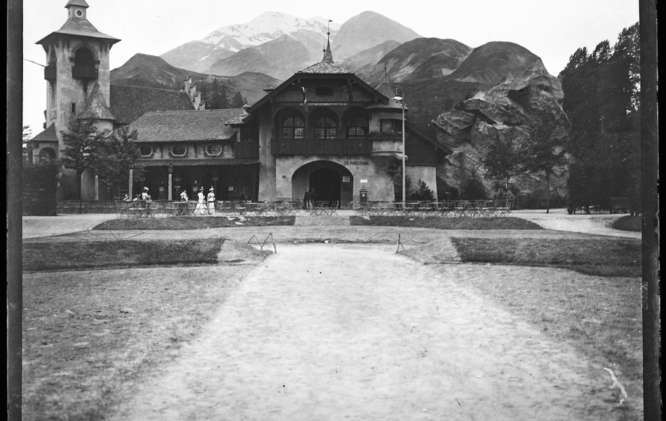 Photographie noir et blanc montrant un bâtiment devant une montagne.